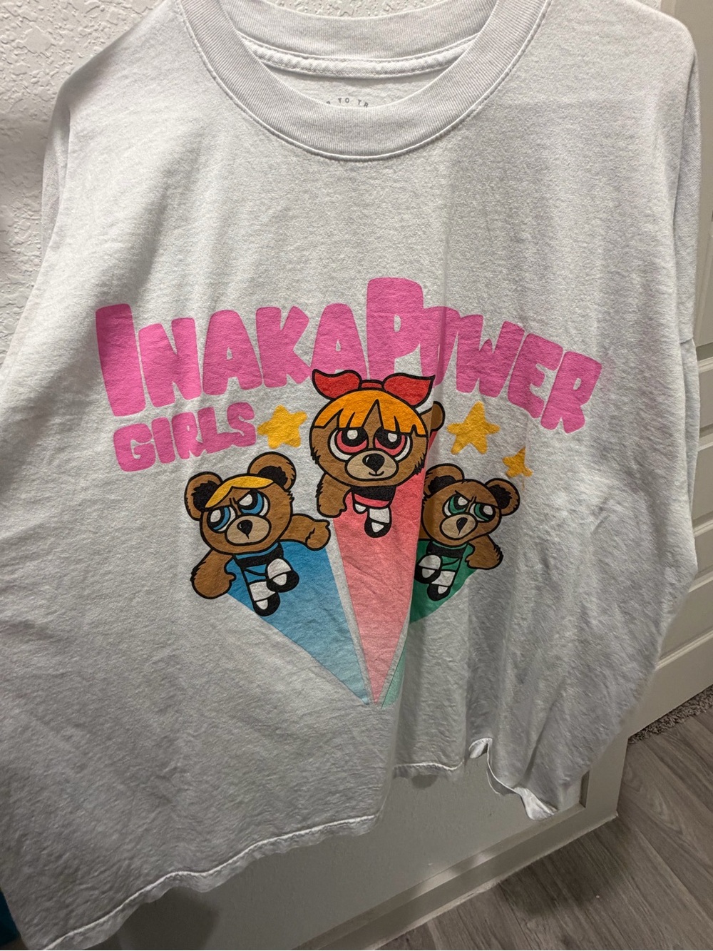 Aria White Tee with Pink 'INAKAPOWER' Graphic and Colorful Character Print